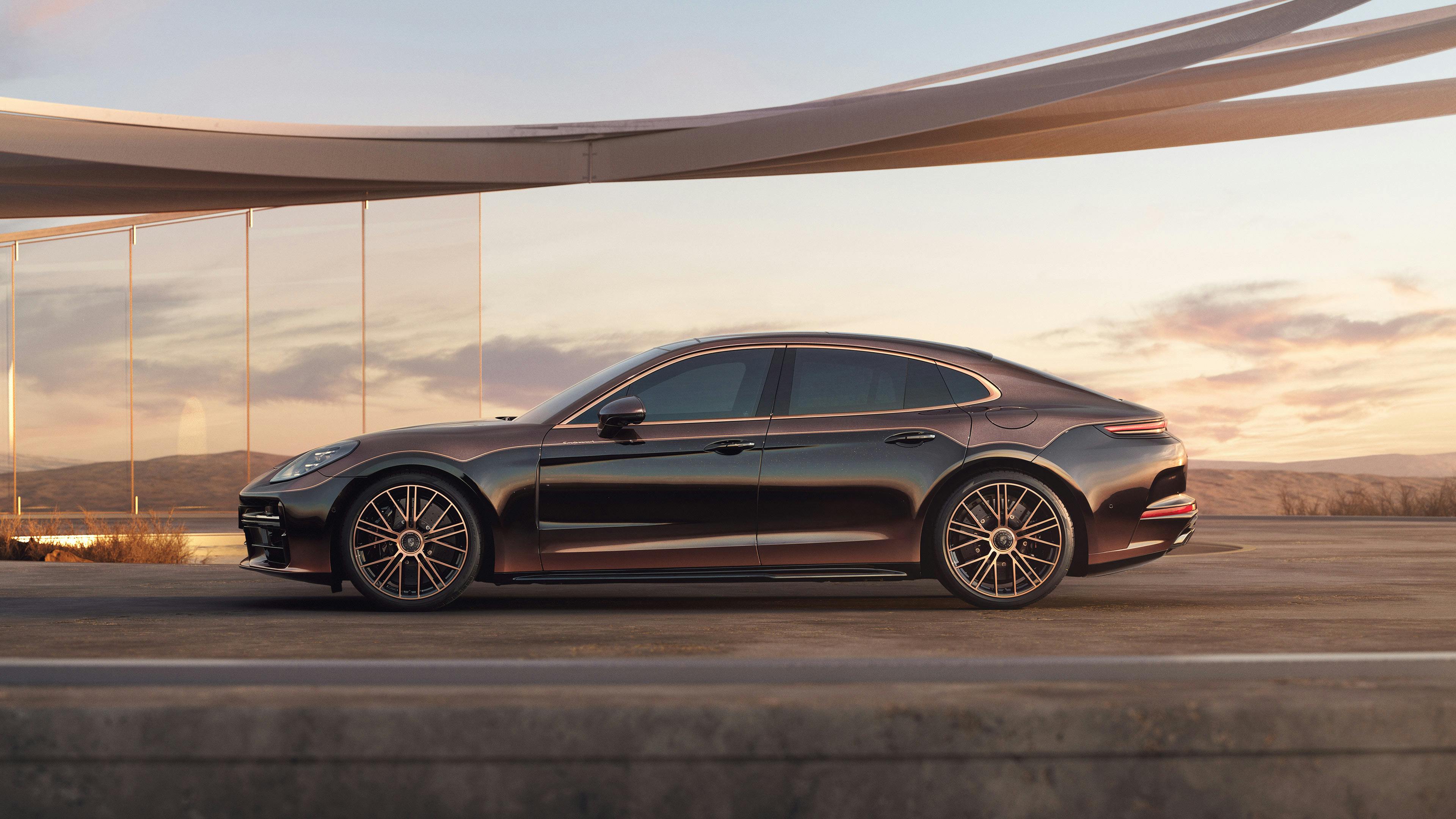 A Porsche Panamera Turbo in Violet Metallic on a road with a mountainous landscape in the background.
