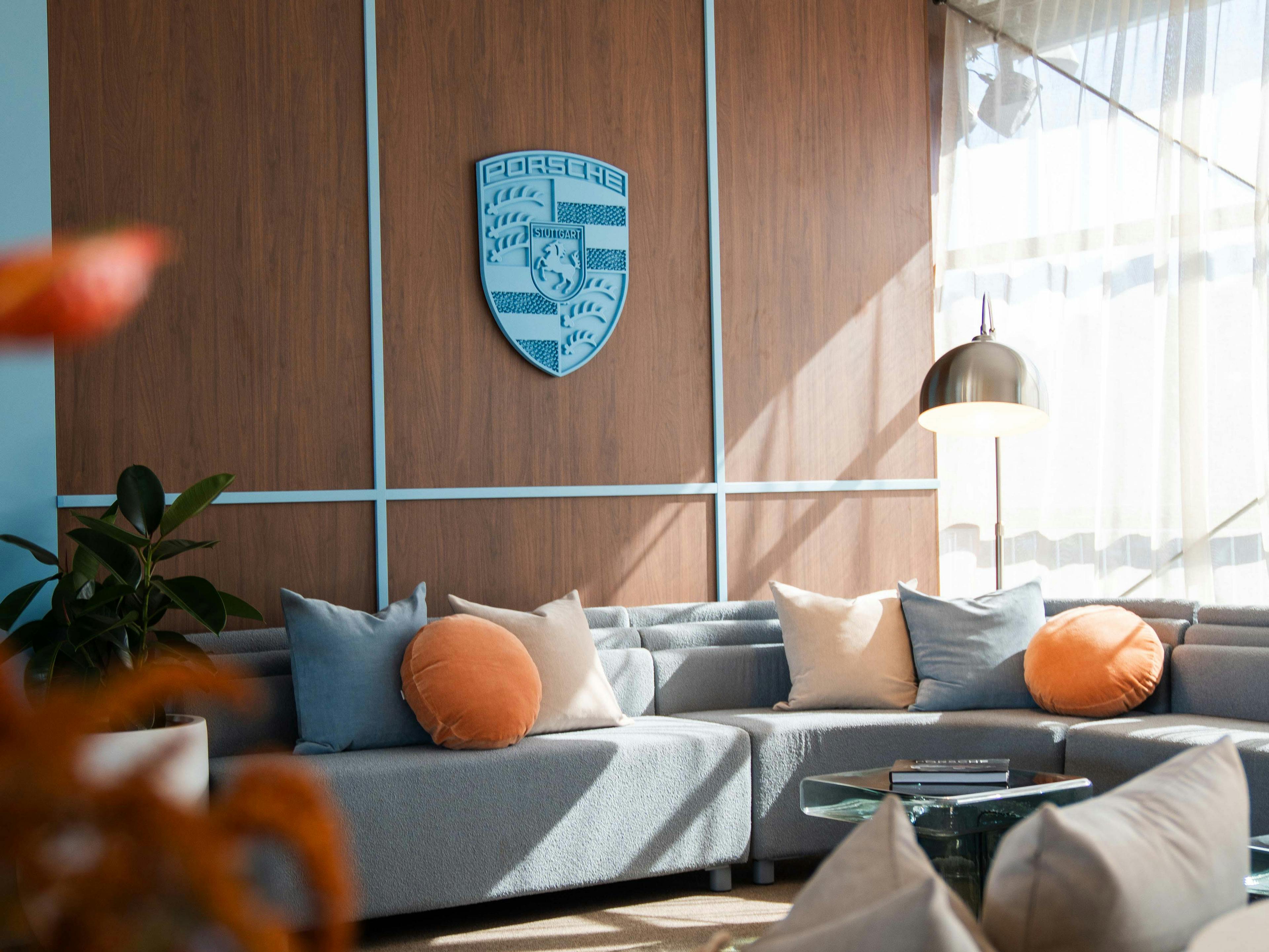 Blue Porsche Crest in premium lounge setting