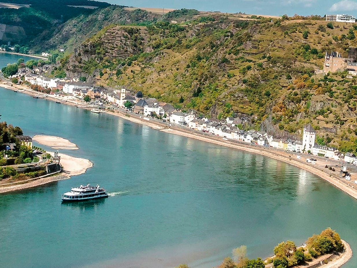 View from above of the Rhine as a boat sails along it.