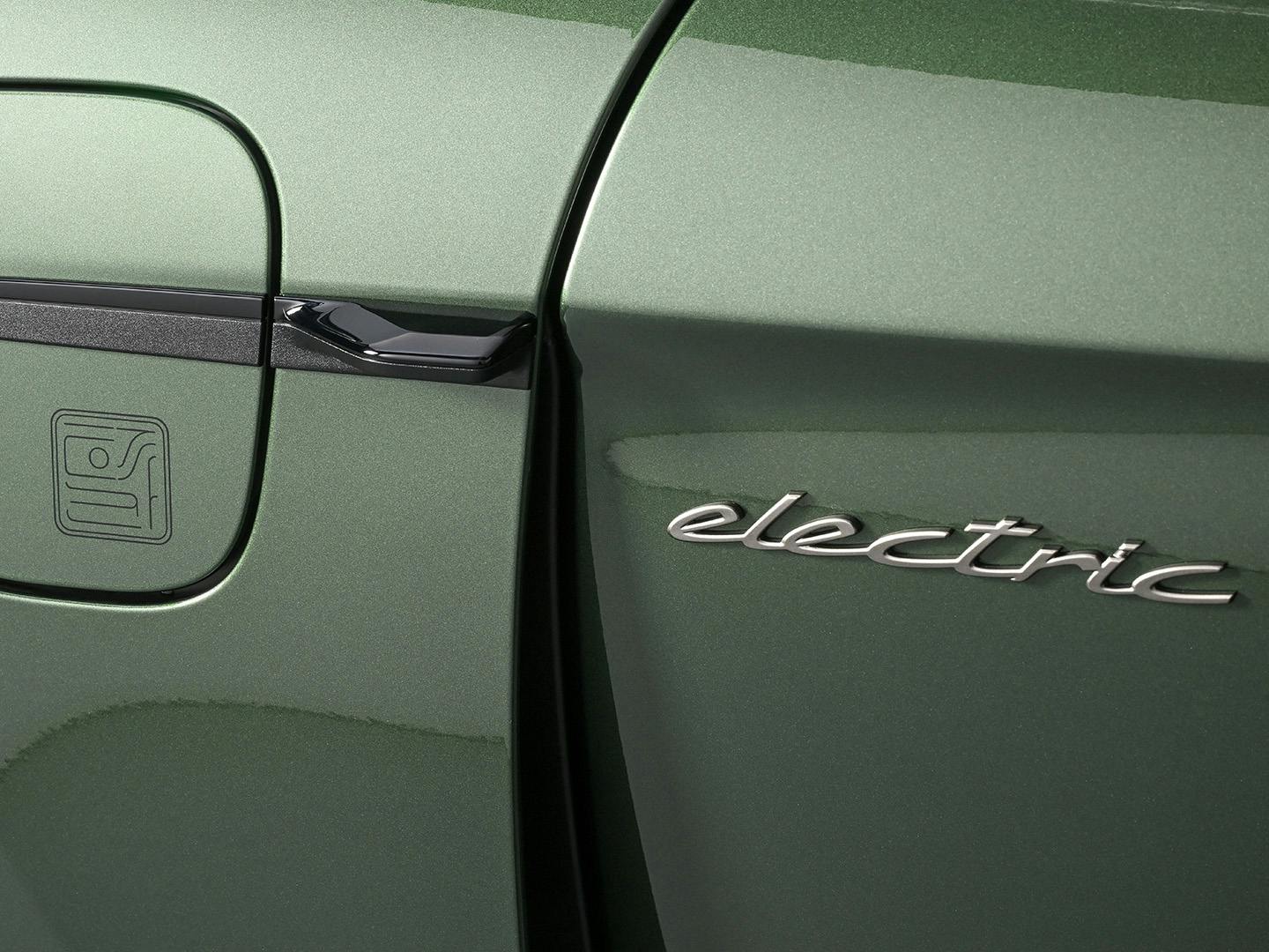 Close-up of a green Porsche electric car, showing the charging port cover with an embossed charging symbol on the left and the word "electric" in sleek chrome lettering on the right.