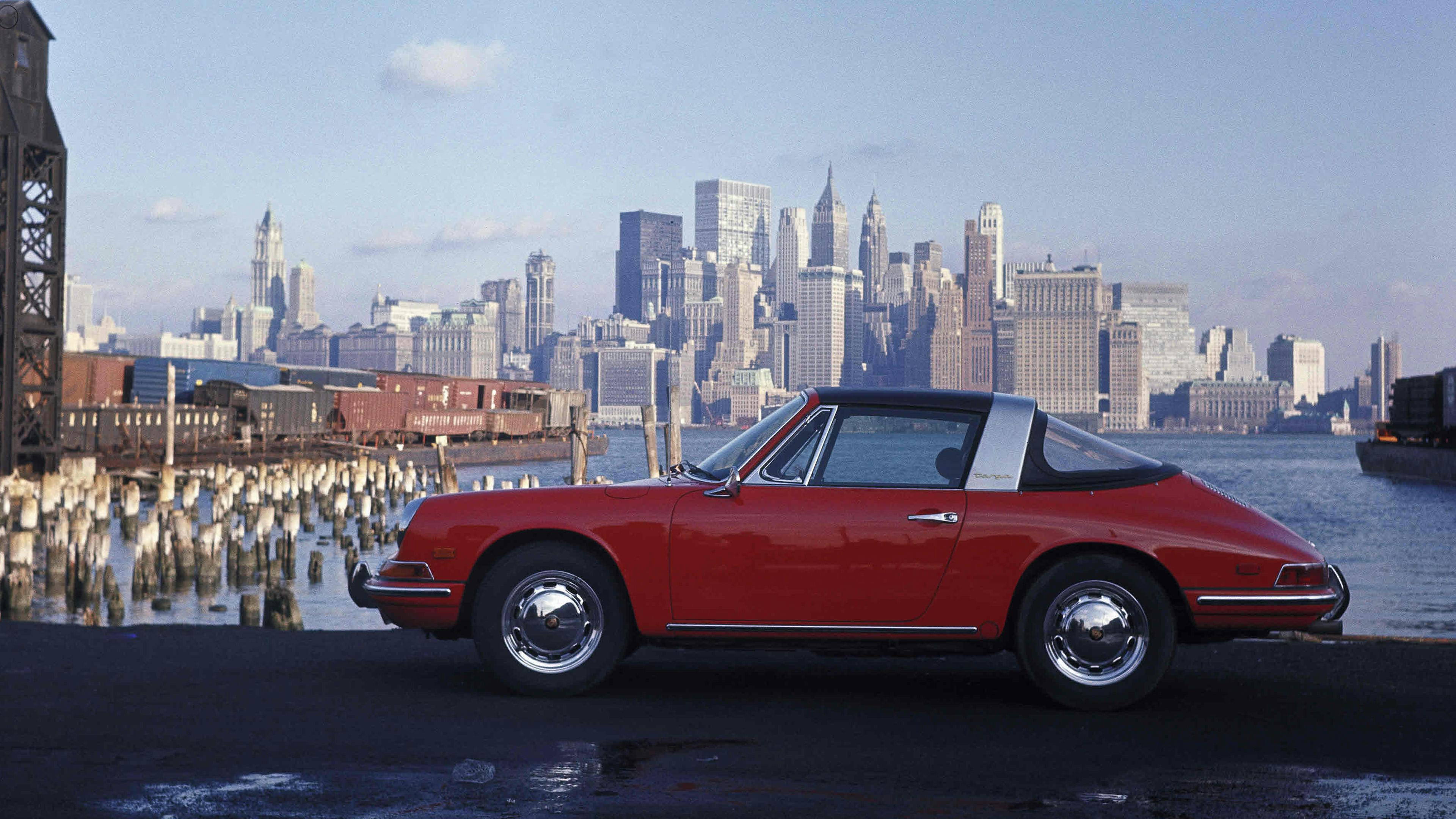 Red Porsche 912 1.6 Targa (1967–69) against the backdrop of a city.