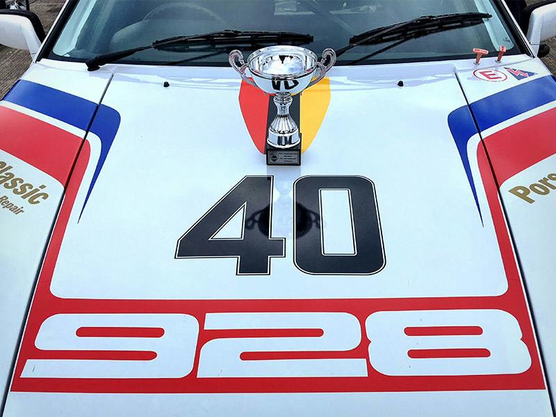 The Silverstone Finals trophy standing on the bonnet of the Porsche 928.