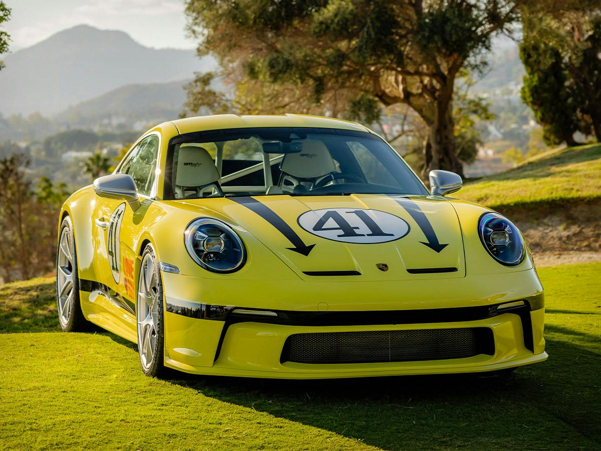 Porsche 911 S/T in Paint to Sample colour 1972classicYellow with individualised painted exterior elements, shown on a grassy landscape.