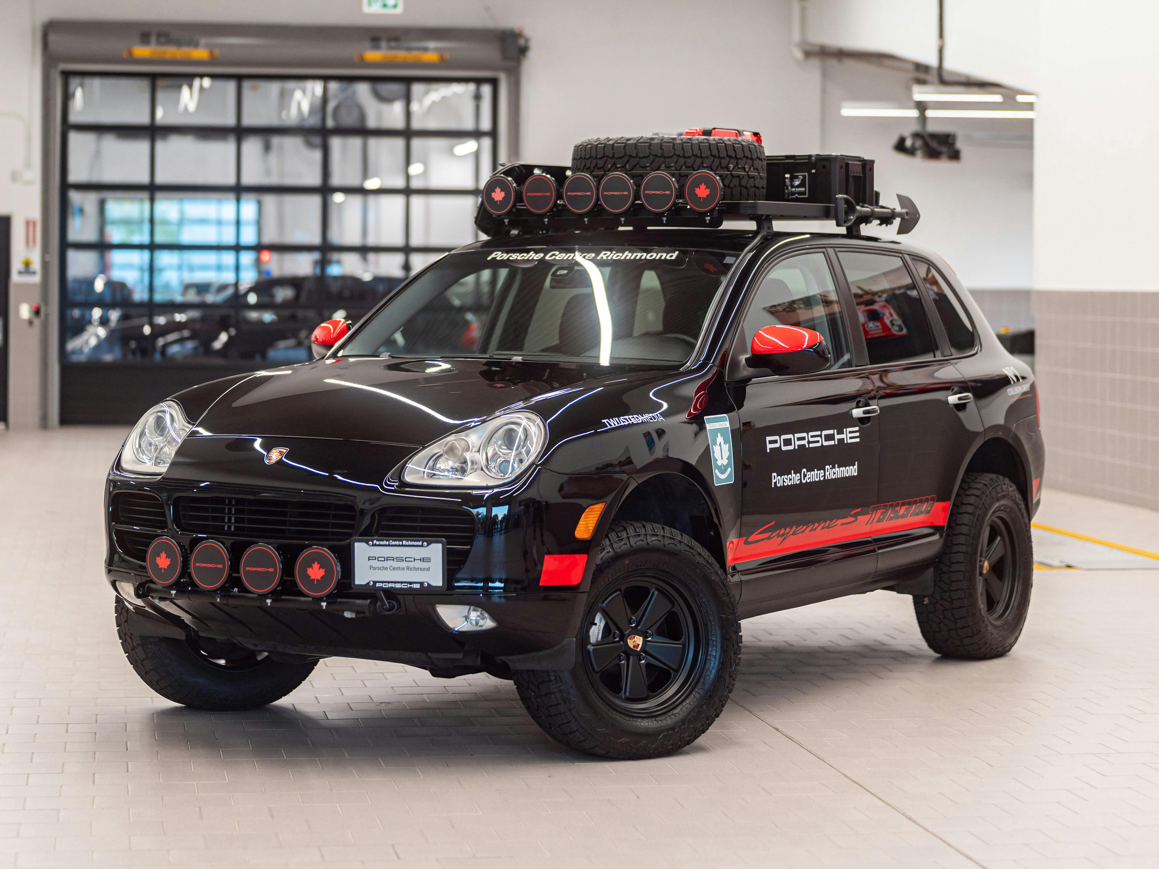 Richmond – A black Porsche Cayenne shown in a bright and spacious service bay.