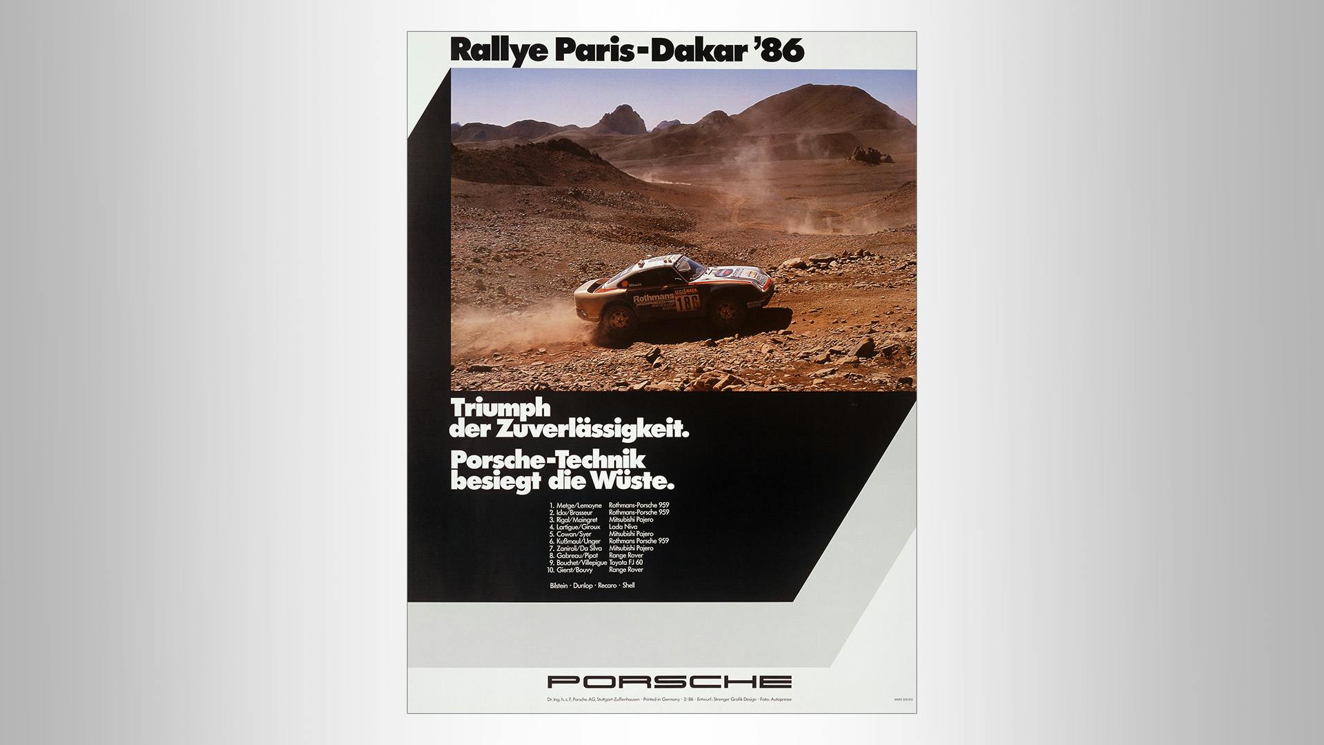 Victory poster with a picture of a Porsche racecar in the desert and the writing: Paris-Dakar 1986.