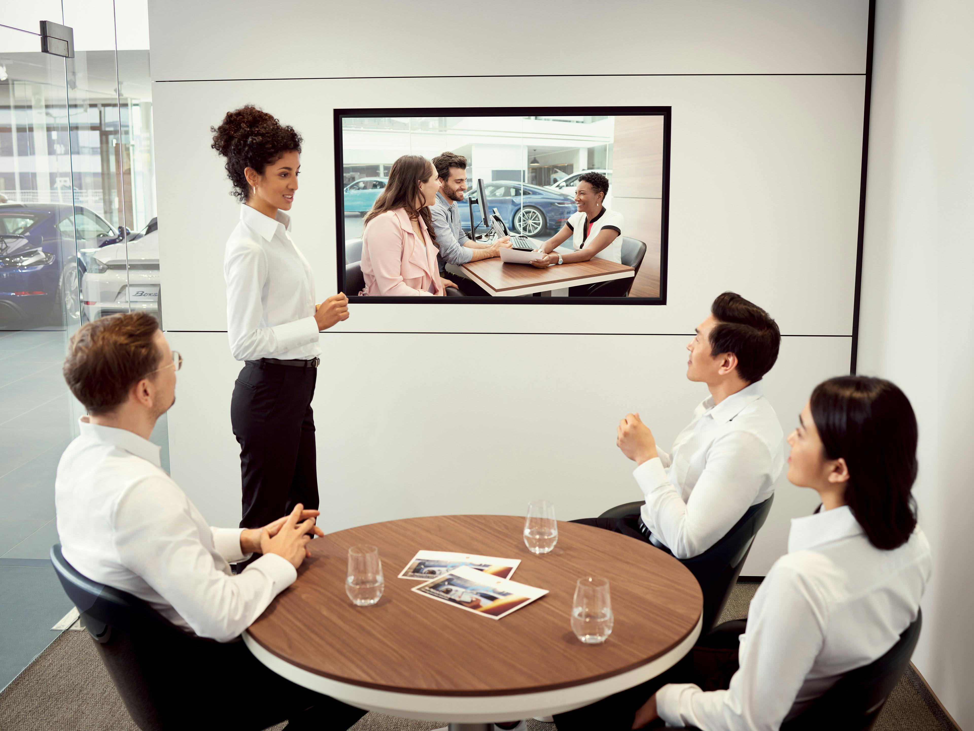 A group of colleagues sitting around a table, in a meeting.