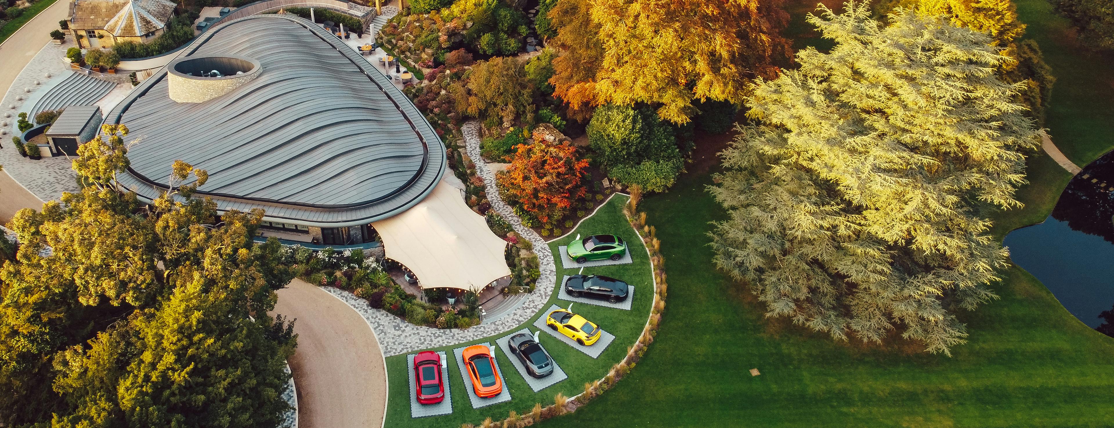 An aerial image of Grantley Hall's grounds in Yorkshire, including a selection of 6 colourful Porsche models.