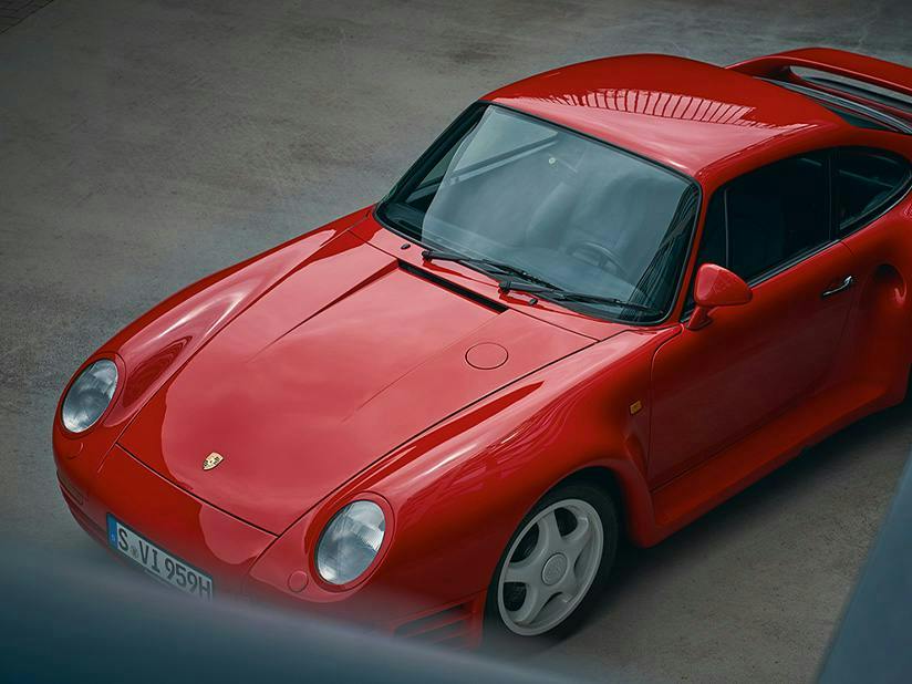 A red Porsche 959 parked, viewed from above.