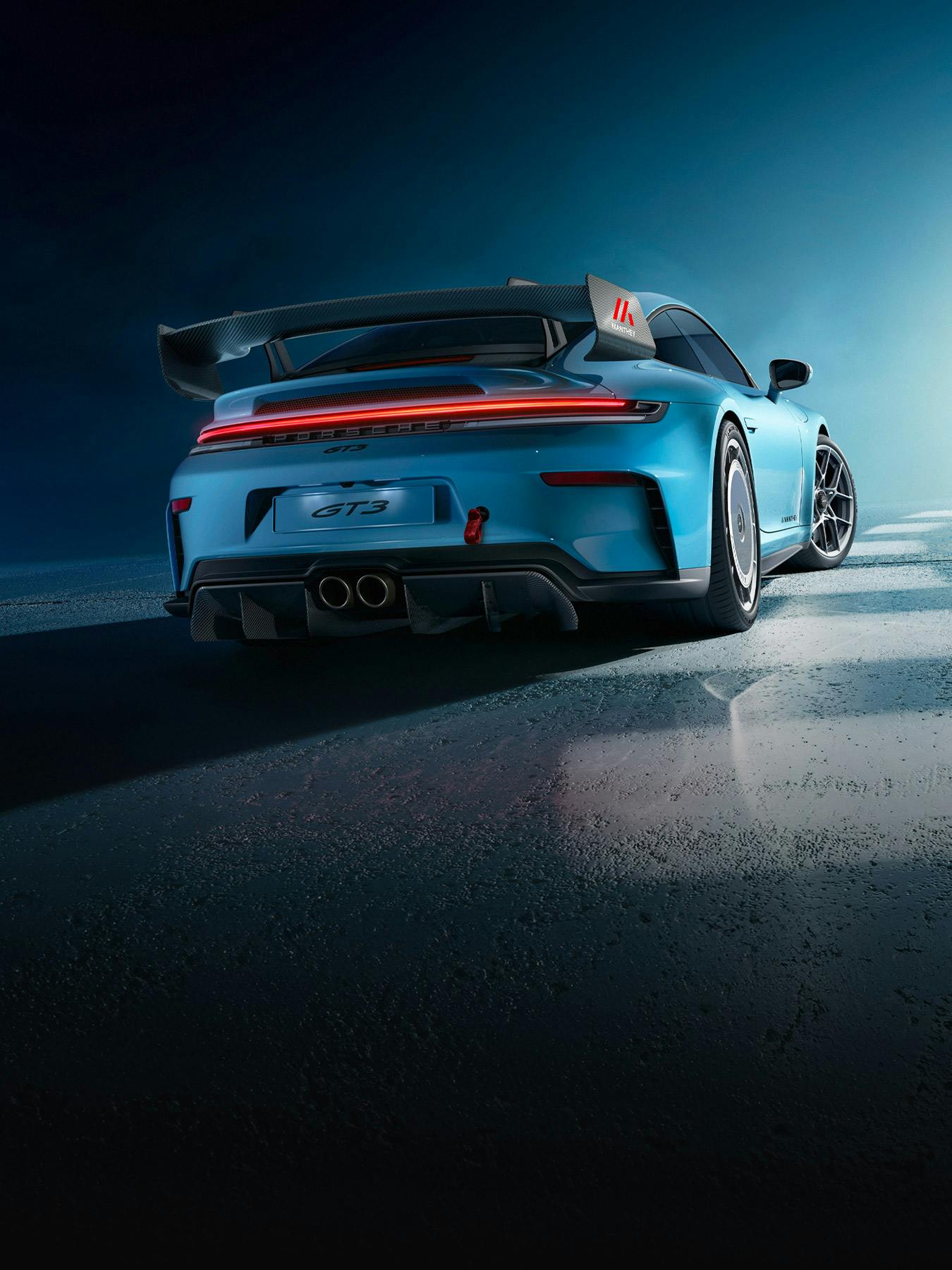 Rear view of a blue Porsche 911 GT3 (992) with Manthey performance kit.