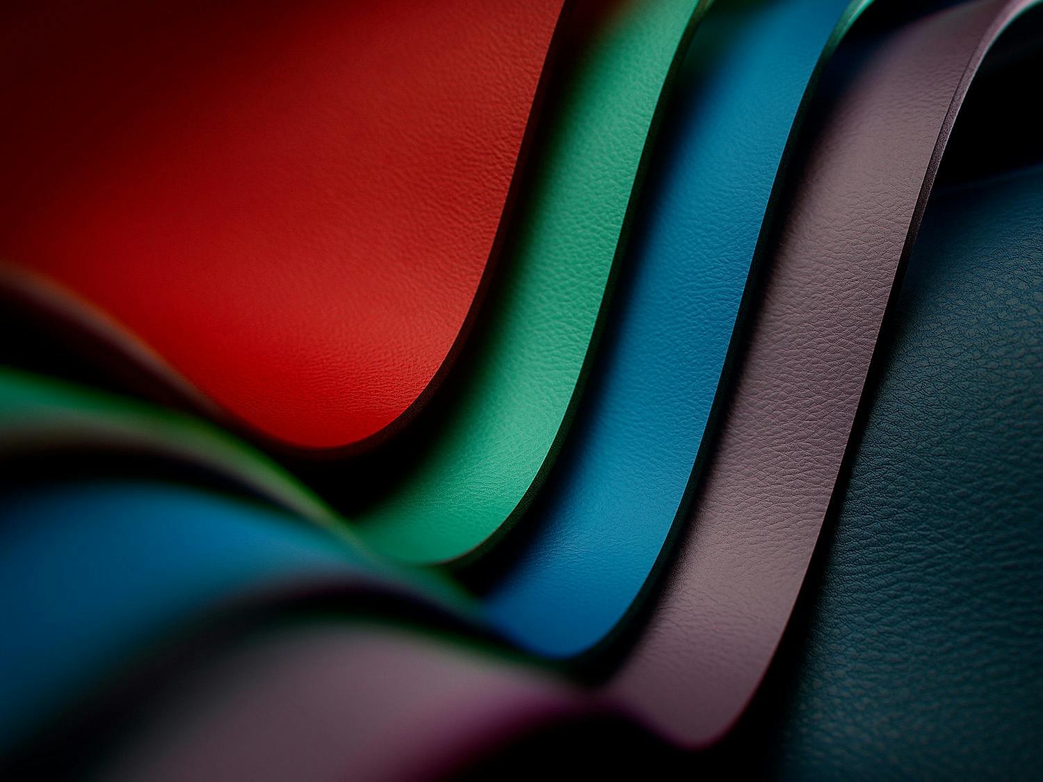 Leather samples in five different colours, layered on top of each other in a curved pattern.