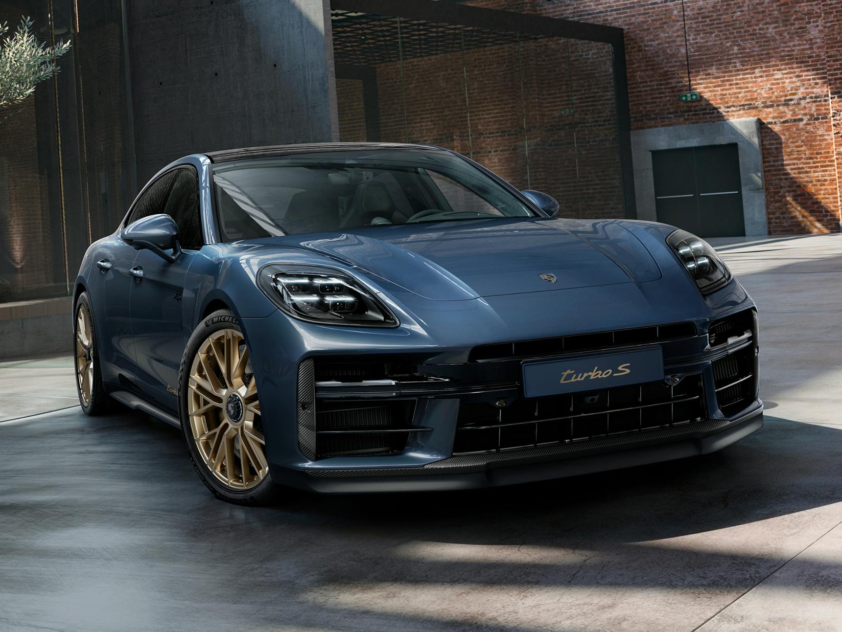 Front view of the front of the Porsche Exclusive Manufaktur Panamera Turbo S E-Hybrid in Yachting Blue Metallic with Aerokit Carbon.