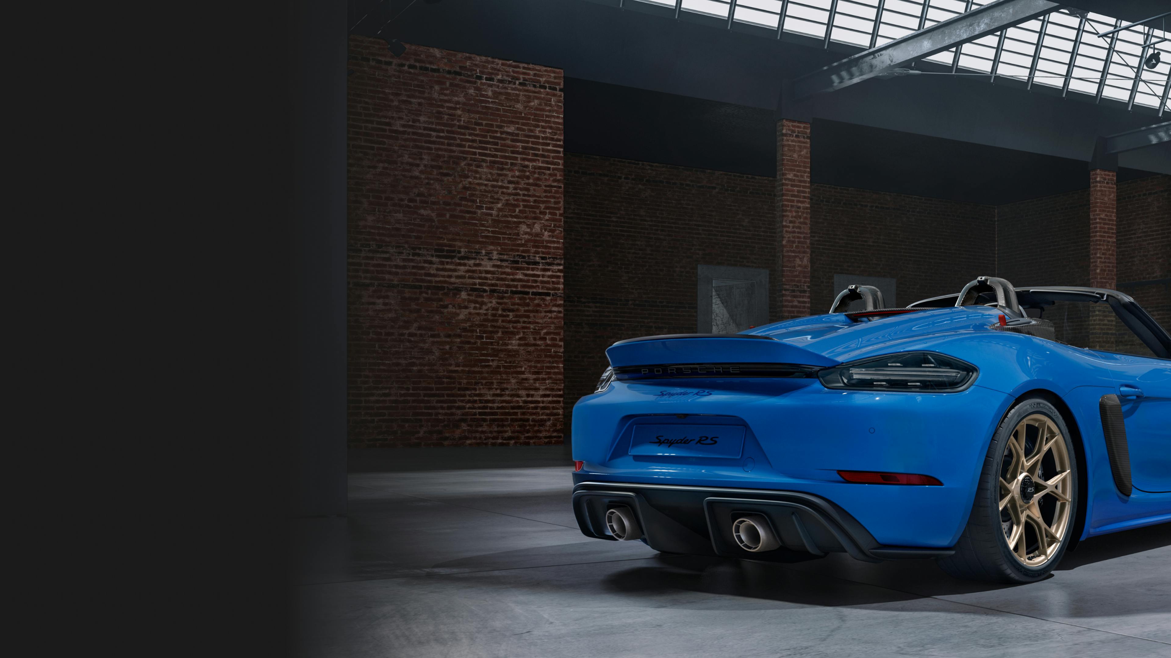 Porsche Exclusive Manufaktur 718 Spyder RS in a warehouse. View of rear end.